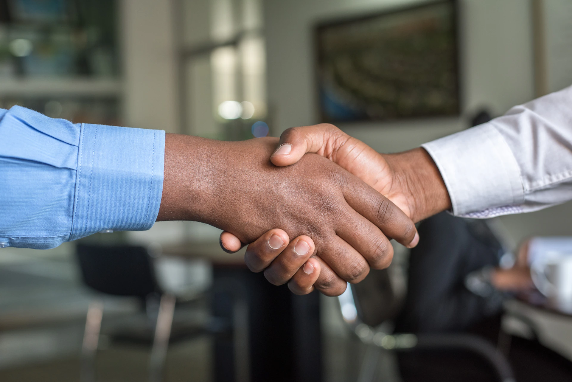 Original Insurance broker shaking hands with a new client in Downey, CA